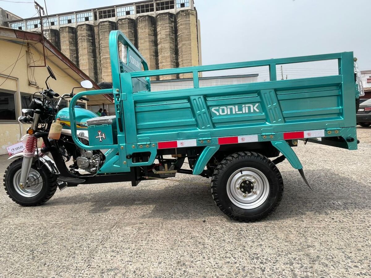 Teal cargo tricycle with an open load bed