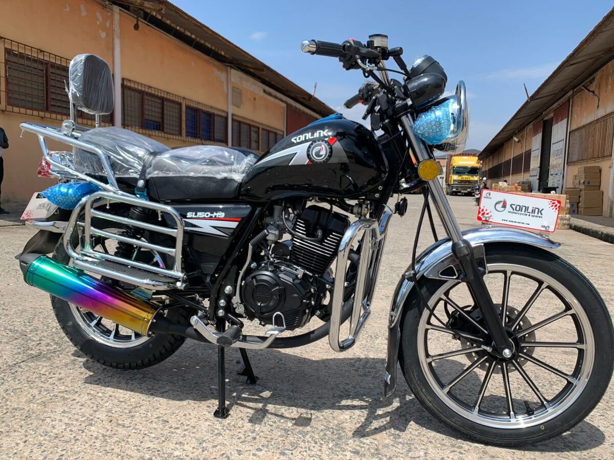 Black street bike with chrome guards in the warehouse