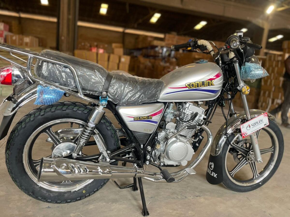 Silver street bike in its plastic in the warehouse